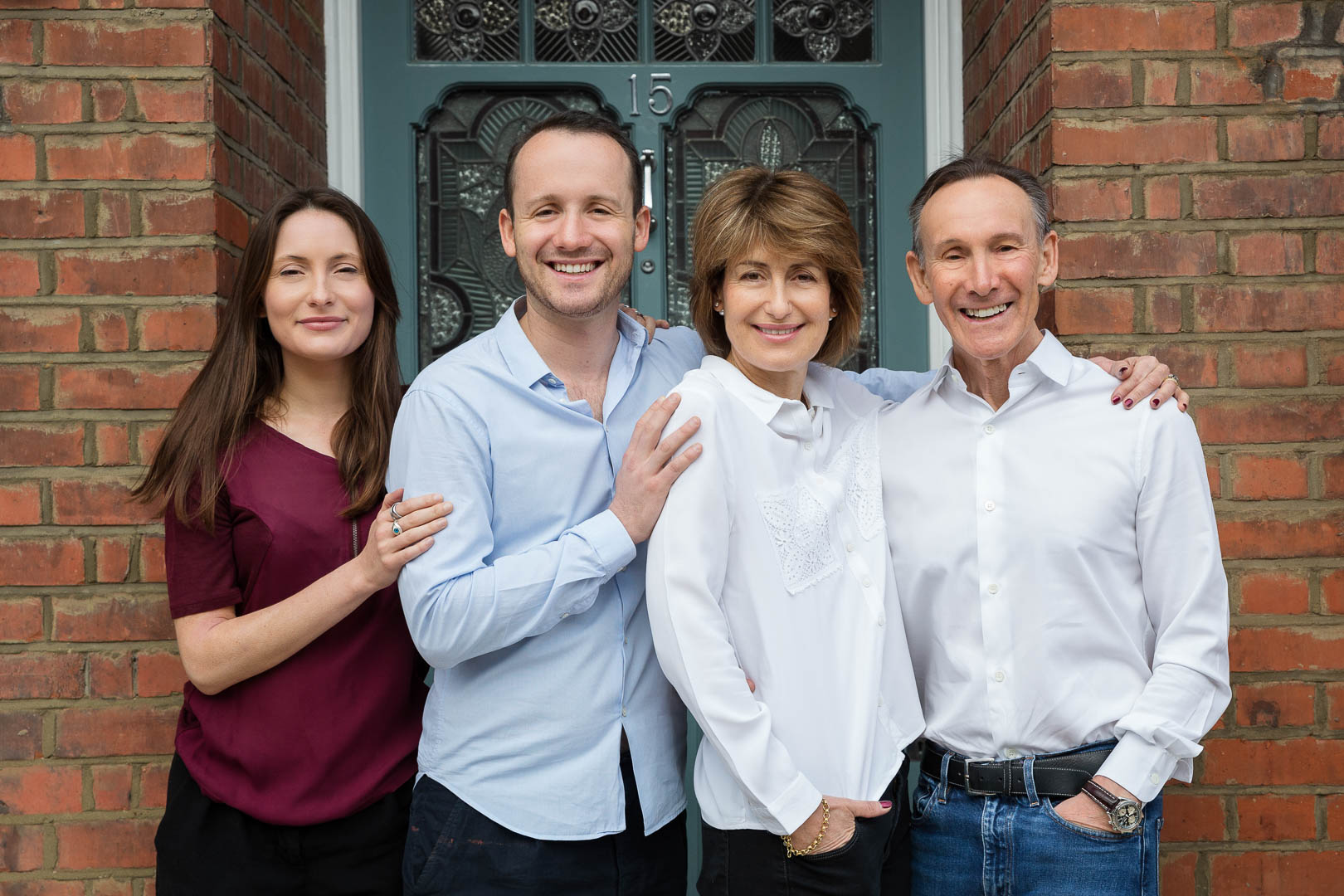 London Family Photographer London adult family of four on doorstep of their house